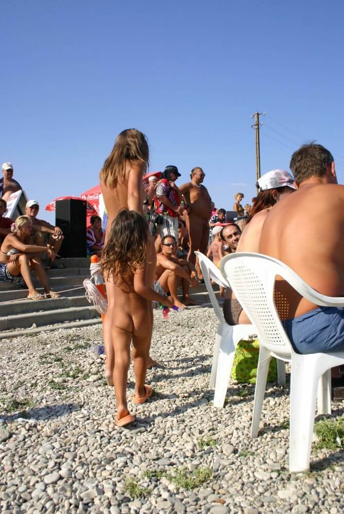 Naturist Standing Sideline - Active naturists on vacation