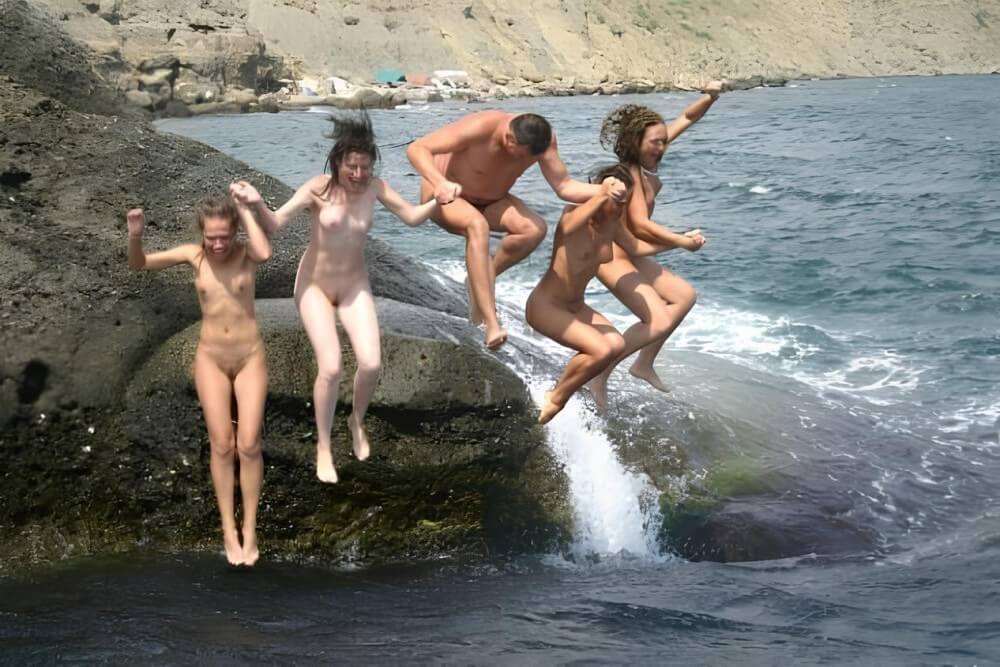 Mens and girls nudists on a beach - Nudism is part of life
