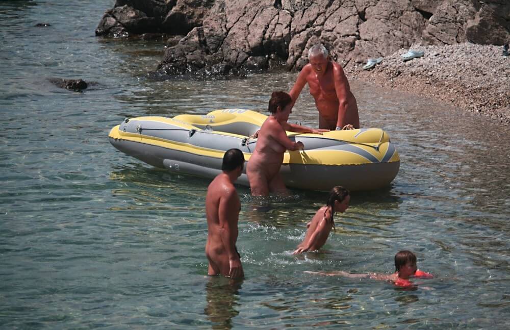 Lone Nudist in Yellow Boat photos - Nudism helps overcome shyness and insecurities